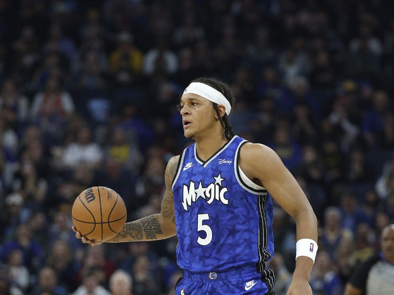 SAN FRANCISCO, CALIFORNIA - JANUARY 02: Paolo Banchero #5 of the Orlando Magic dribbles the ball up court against the Golden State Warriors during the first quarter of an NBA basketball game at Chase Center on January 02, 2024 in San Francisco, California. NOTE TO USER: User expressly acknowledges and agrees that, by downloading and or using this photograph, User is consenting to the terms and conditions of the Getty Images License Agreement. (Photo by Thearon W. Henderson/Getty Images)