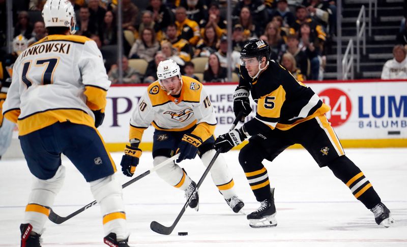 Apr 15, 2024; Pittsburgh, Pennsylvania, USA;  Pittsburgh Penguins defenseman Ryan Shea (5) skates with the puck against the Nashville Predators during the third period at PPG Paints Arena. The Penguins won 4-2. Mandatory Credit: Charles LeClaire-USA TODAY Sports