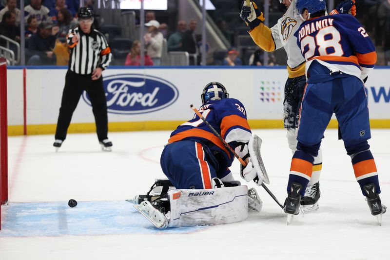 Mar 1, 2025; Elmont, New York, USA;  The puck gets by New York Islanders goaltender Ilya Sorokin (30) for a goal by Nashville Predators left wing Cole Smith (36) during the third period at UBS Arena. Mandatory Credit: Thomas Salus-Imagn Images