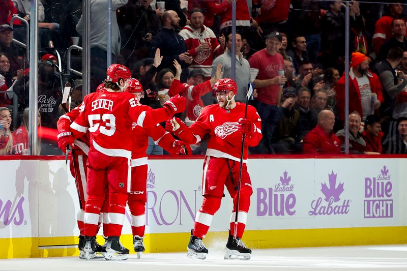 Nov 30, 2023; Detroit, Michigan, USA;  Detroit Red Wings center Robby Fabbri (14) receives congratulations from teammates after scoring in the first period against the Chicago Blackhawks at Little Caesars Arena. Mandatory Credit: Rick Osentoski-USA TODAY Sports