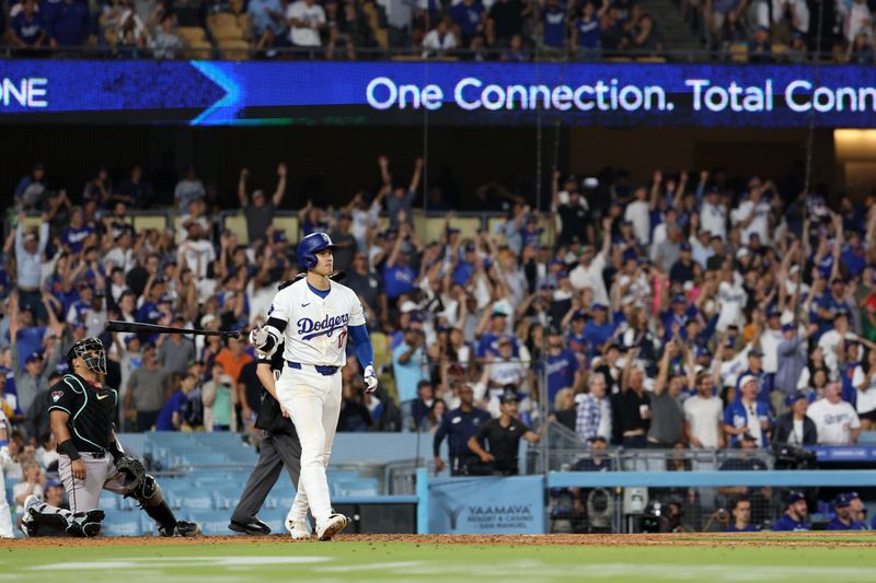 Jul 2, 2024; Los Angeles, California, USA;  Los Angeles Dodgers designated hitter Shohei Ohtani (17) hits a two-run home run during the seventh inning against the Arizona Diamondbacks at Dodger Stadium. Mandatory Credit: Kiyoshi Mio-USA TODAY Sports