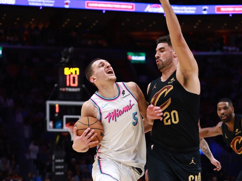 MIAMI, FLORIDA - JANUARY 29: Nikola Jovic #5 of the Miami Heat is defended by Georges Niang #20 of the Cleveland Cavaliers during the first half at Kaseya Center on January 29, 2025 in Miami, Florida.  NOTE TO USER: User expressly acknowledges and agrees that, by downloading and or using this Photograph, user is consenting to the terms and conditions of the Getty Images License Agreement. (Photo by Carmen Mandato/Getty Images)