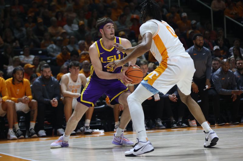 Feb 7, 2024; Knoxville, Tennessee, USA; LSU Tigers forward Will Baker (9) moves the ball against Tennessee Volunteers forward Jonas Aidoo (0) during the first half at Thompson-Boling Arena at Food City Center. Mandatory Credit: Randy Sartin-USA TODAY Sports