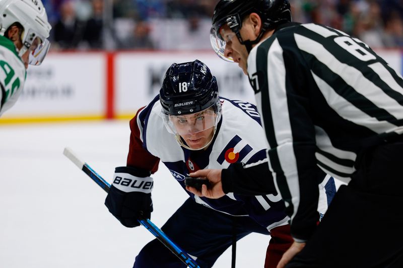 Mar 18, 2026; Denver, Colorado, USA; Colorado Avalanche center Jack Drury (18) watches the puck in the hand of linesman Devin Berg (87) before a face off in the second period against the Dallas Stars at Ball Arena. Mandatory Credit: Isaiah J. Downing-Imagn Images
