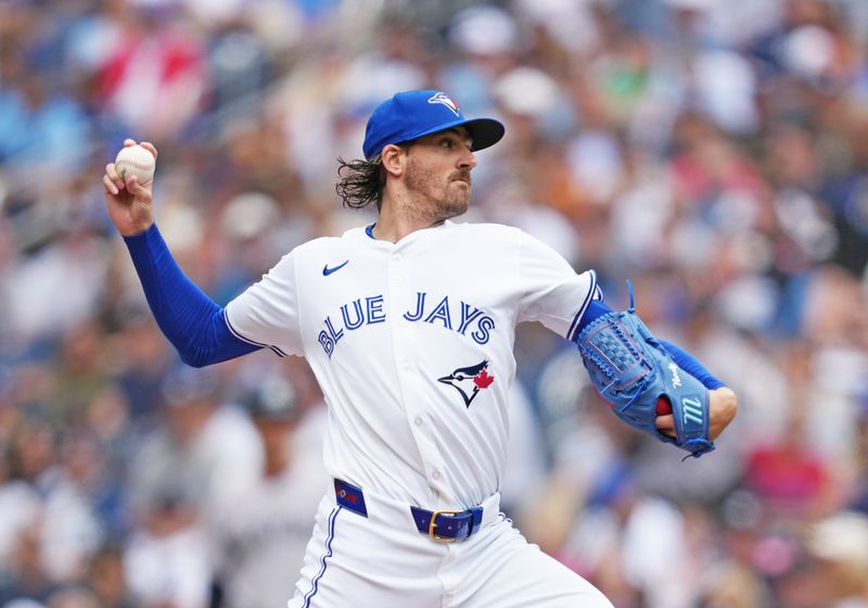 Jun 30, 2024; Toronto, Ontario, CAN; Toronto Blue Jays starting pitcher Kevin Gausman (34) throws a pitch game against the New York Yankees during the first inning at Rogers Centre. Mandatory Credit: Nick Turchiaro-USA TODAY Sports