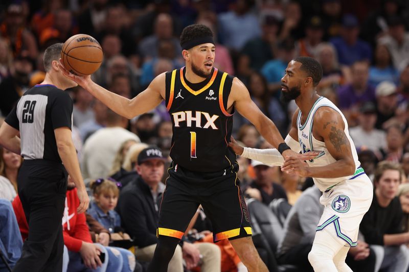 PHOENIX, ARIZONA - NOVEMBER 15: Devin Booker #1 of the Phoenix Suns handles the ball against Mike Conley #10 of the Minnesota Timberwolves during the first half of the NBA game at Footprint Center on November 15, 2023 in Phoenix, Arizona. NOTE TO USER: User expressly acknowledges and agrees that, by downloading and or using this photograph, User is consenting to the terms and conditions of the Getty Images License Agreement.  (Photo by Christian Petersen/Getty Images)