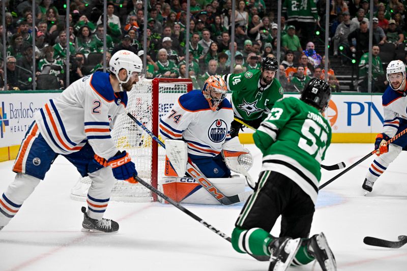 May 25, 2024; Dallas, Texas, USA; Edmonton Oilers defenseman Evan Bouchard (2) and goaltender Stuart Skinner (74) face a shot by Dallas Stars center Wyatt Johnston (53) and left wing Jamie Benn (14) during the second period in game two of the Western Conference Final of the 2024 Stanley Cup Playoffs at American Airlines Center. Mandatory Credit: Jerome Miron-USA TODAY Sports