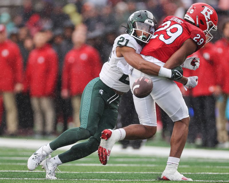 Oct 14, 2023; Piscataway, New Jersey, USA; Michigan State Spartans defensive back Dillon Tatum (21) breaks up a pass intended for Rutgers Scarlet Knights wide receiver Ian Strong (29) during the first half at SHI Stadium. Mandatory Credit: Vincent Carchietta-USA TODAY Sports