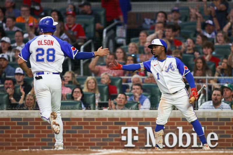 May 6, 2023; Atlanta, Georgia, USA; Atlanta Braves first baseman Matt Olson (28) celebrates after scoring with second baseman Ozzie Albies (1) against the Baltimore Orioles in the fourth inning at Truist Park. Mandatory Credit: Brett Davis-USA TODAY Sports
