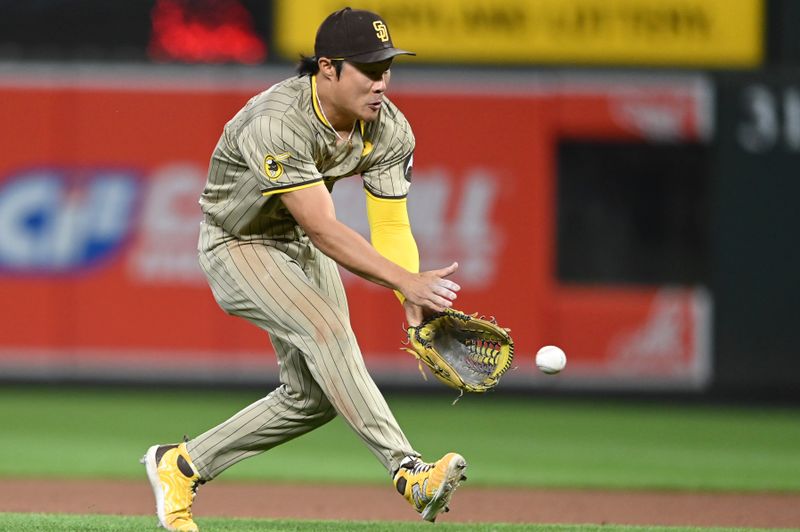 Jul 26, 2024; Baltimore, Maryland, USA;  San Diego Padres shortstop Ha-Seong Kim (7) fields a eighth inning ground ball against the Baltimore Orioles at Oriole Park at Camden Yards. Mandatory Credit: Tommy Gilligan-USA TODAY Sports