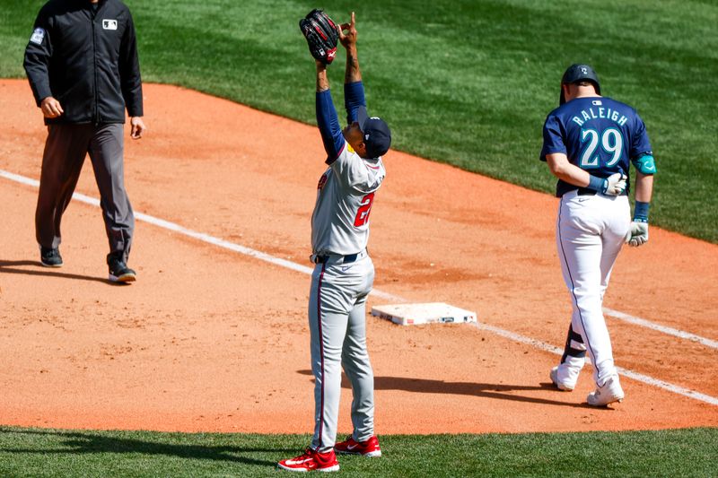 May 1, 2024; Seattle, Washington, USA; Atlanta Braves relief pitcher Raisel Iglesias (26) and Seattle Mariners designated hitter Cal Raleigh (29) react following the final out of a 5-2 Atlanta victory at T-Mobile Park. Mandatory Credit: Joe Nicholson-USA TODAY Sports