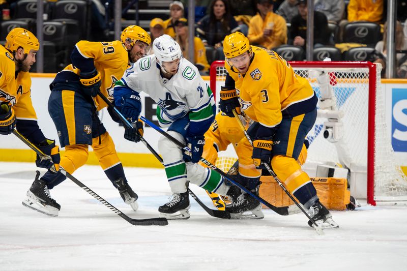 May 3, 2024; Nashville, Tennessee, USA; Nashville Predators defenseman Jeremy Lauzon (3) blocks the shot of Vancouver Canucks center Pius Suter (24) during the second period in game six of the first round of the 2024 Stanley Cup Playoffs at Bridgestone Arena. Mandatory Credit: Steve Roberts-USA TODAY Sports