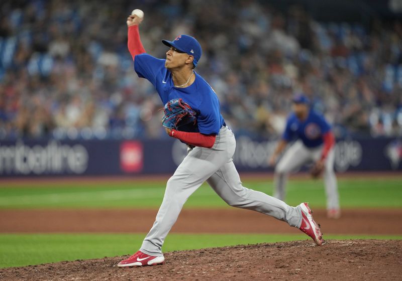 Aug 11, 2023; Toronto, Ontario, CAN; Chicago Cubs relief pitcher Adbert Alzolay (73) throws a pitch against the Toronto Blue Jays during the ninth inning at Rogers Centre. Mandatory Credit: Nick Turchiaro-USA TODAY Sports