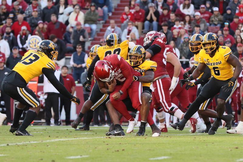 Nov 24, 2023; Fayetteville, Arkansas, USA; Arkansas Razorbacks quarterback Jacolby Criswell (6) is tackled by Missouri Tigers linebacker Brayshawn Littlejohn (16) during the first half at Donald W. Reynolds Razorback Stadium. Mandatory Credit: Nelson Chenault-USA TODAY Sports