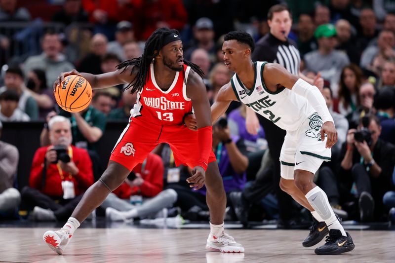 Mar 10, 2023; Chicago, IL, USA; Ohio State Buckeyes guard Isaac Likekele (13) is defended by Michigan State Spartans guard Tyson Walker (2) during the second half at United Center. Mandatory Credit: Kamil Krzaczynski-USA TODAY Sports