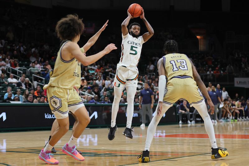 Feb 24, 2024; Coral Gables, Florida, USA; Miami Hurricanes guard Wooga Poplar (5) passes the basketball against the Georgia Tech Yellow Jackets during the second half at Watsco Center. Mandatory Credit: Sam Navarro-USA TODAY Sports