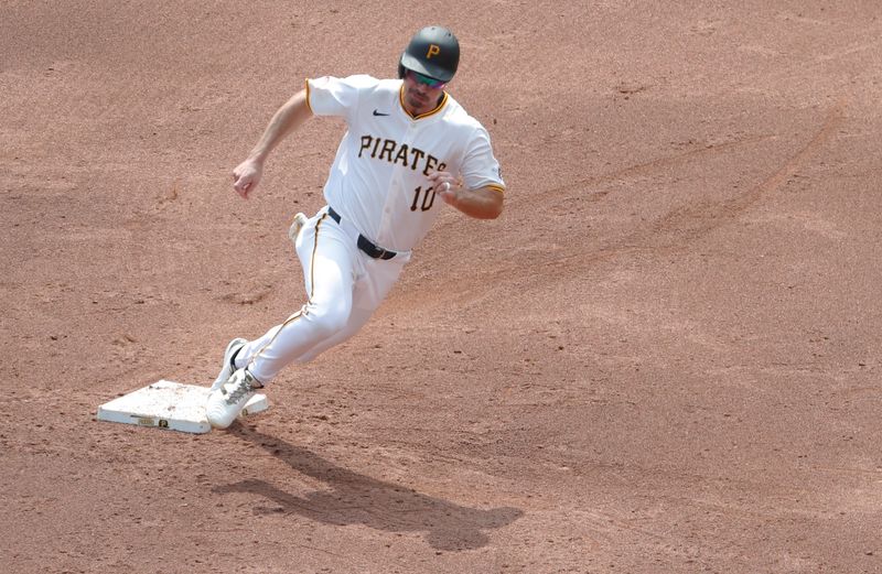 Aug 25, 2024; Pittsburgh, Pennsylvania, USA;  Pittsburgh Pirates left fielder Bryan Reynolds (10) rounds second base on his way to third base against the Cincinnati Reds during the third inning at PNC Park. Mandatory Credit: Charles LeClaire-USA TODAY Sports