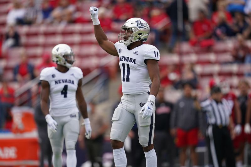 Oct 23, 2021; Fresno, California, USA; Nevada Wolf Pack linebacker Daiyan Henley (11) reacts after a defensive stop against the Fresno State Bulldogs on third down in the first quarter at Bulldog Stadium. Mandatory Credit: Cary Edmondson-USA TODAY Sports