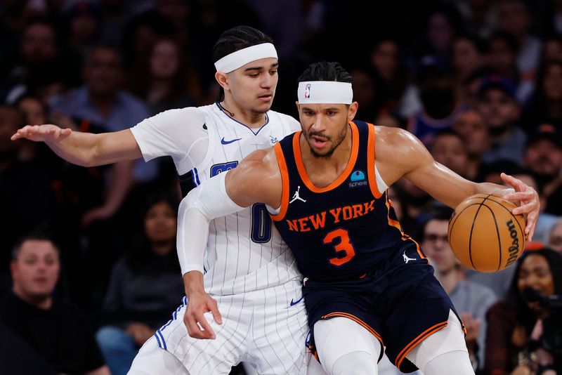 NEW YORK, NEW YORK - MARCH 08: Josh Hart #3 of the New York Knicks dribbles against Anthony Black #0 of the Orlando Magic during the first half at Madison Square Garden on March 08, 2024 in New York City. NOTE TO USER: User expressly acknowledges and agrees that, by downloading and or using this photograph, User is consenting to the terms and conditions of the Getty Images License Agreement. (Photo by Sarah Stier/Getty Images)