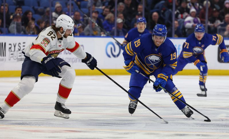 Feb 15, 2024; Buffalo, New York, USA;  Buffalo Sabres center Peyton Krebs (19) skates with the puck as Florida Panthers center Kevin Stenlund (82) defends during the second period at KeyBank Center. Mandatory Credit: Timothy T. Ludwig-USA TODAY Sports