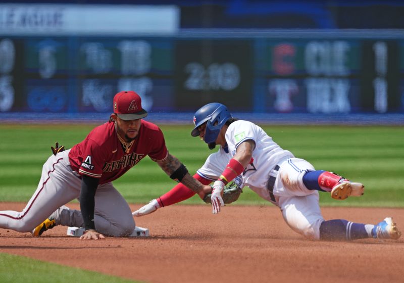 Jul 16, 2023; Toronto, Ontario, CAN; Toronto Blue Jays second baseman Santiago Espinal (5) is tagged out at second base by Arizona Diamondbacks second baseman Ketel Marte (4) during the fourth inning at Rogers Centre. Mandatory Credit: Nick Turchiaro-USA TODAY Sports