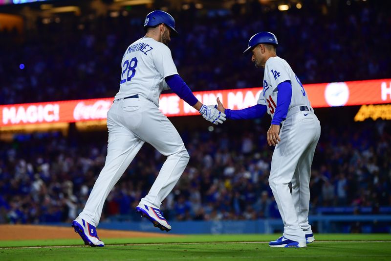 Sep 21, 2023; Los Angeles, California, USA; Los Angeles Dodgers designated hitter J.D. Martinez (28) is greeted by third base coach Dino Ebel (91) after hitting a solo home run against the San Francisco Giants during the fourth inning at Dodger Stadium. Mandatory Credit: Gary A. Vasquez-USA TODAY Sports