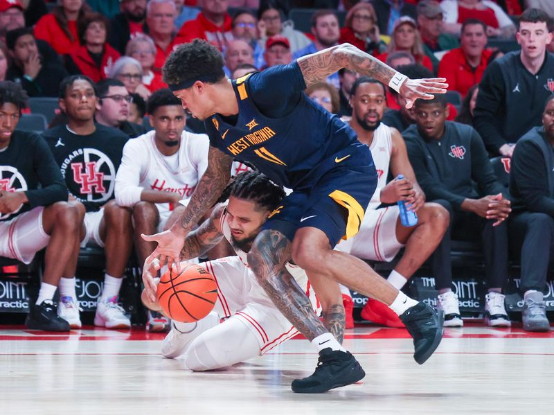 Jan 15, 2025; Houston, Texas, USA; Houston Cougars guard Emanuel Sharp (21) dribbles against West Virginia Mountaineers guard Jonathan Powell (11) in the second half at Fertitta Center. Mandatory Credit: Thomas Shea-Imagn Images