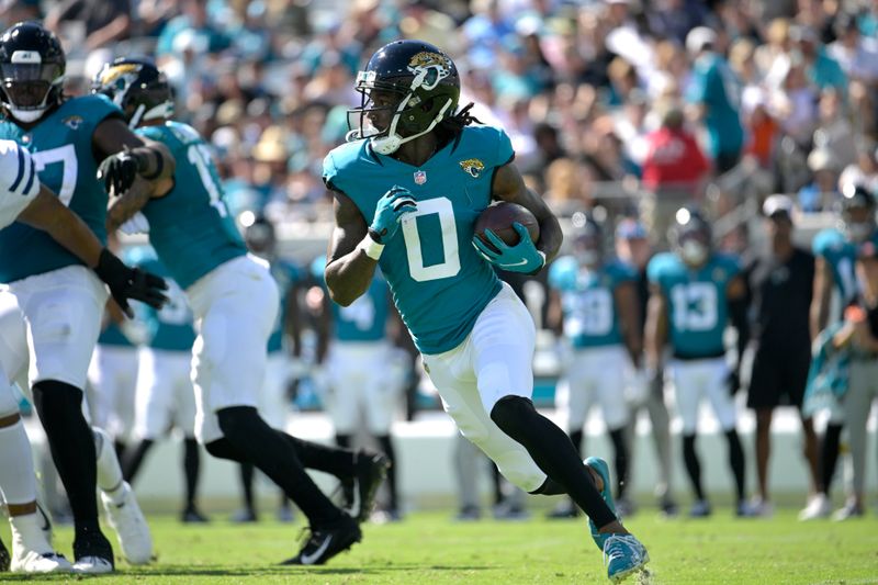 Jacksonville Jaguars wide receiver Calvin Ridley (0) runs after taking the hand off from quarterback Trevor Lawrence during the second half of an NFL football game against the Indianapolis Colts, Sunday, Oct. 15, 2023, in Jacksonville, Fla. (AP Photo/Phelan M. Ebenhack)