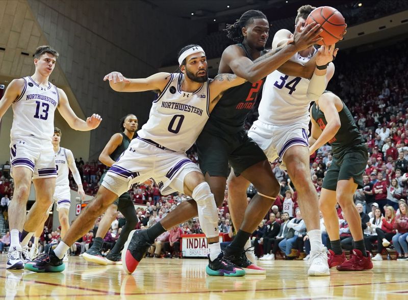 Feb 18, 2024; Bloomington, Indiana, USA;  Northwestern Wildcats guard Boo Buie (0) and Northwestern Wildcats center Matthew Nicholson (34) and Indiana Hoosiers forward Mackenzie Mgbako (21) battle for a rebound during the second half at Simon Skjodt Assembly Hall. Mandatory Credit: Robert Goddin-USA TODAY Sports