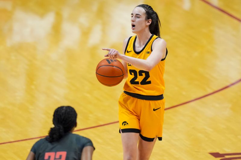 Feb 22, 2024; Bloomington, Indiana, USA;  Iowa Hawkeyes guard Caitlin Clark (22) dribbles the ball as she gestures to teammates in the game against the Indiana Hoosiers in the second half at Simon Skjodt Assembly Hall. Mandatory Credit: Aaron Doster-USA TODAY Sports