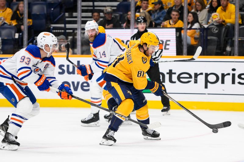 Oct 31, 2024; Nashville, Tennessee, USA;  Nashville Predators center Jonathan Marchessault (81) skates with the puck as Edmonton Oilers center Ryan Nugent-Hopkins (93) chases during the third period at Bridgestone Arena. Mandatory Credit: Steve Roberts-Imagn Images