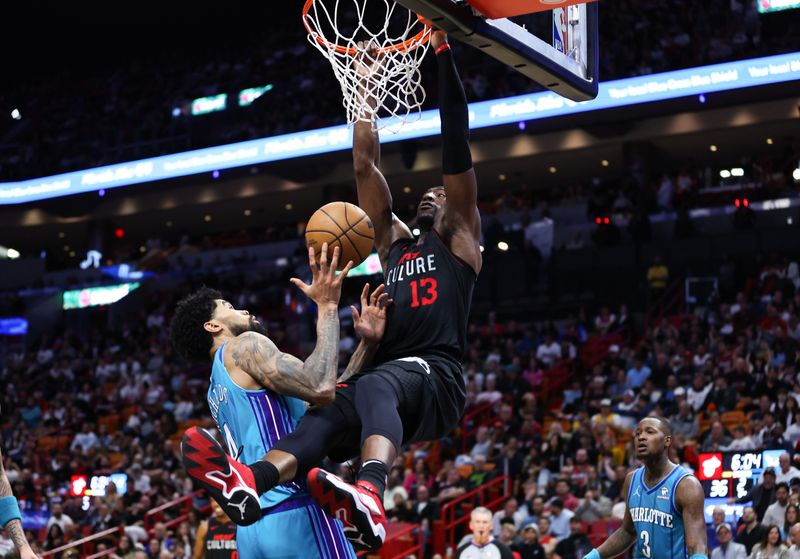 MIAMI, FLORIDA - JANUARY 14: Bam Adebayo #13 of the Miami Heat dunks the ball against the Charlotte Hornets during the first quarter at Kaseya Center on January 14, 2024 in Miami, Florida. NOTE TO USER: User expressly acknowledges and agrees that, by downloading and or using this photograph, User is consenting to the terms and conditions of the Getty Images License Agreement.  (Photo by Megan Briggs/Getty Images)