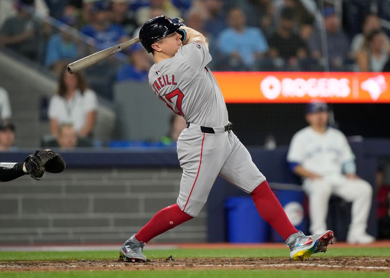 Jun 18, 2024; Toronto, Ontario, CAN; Boston Red Sox left fielder Tyler O'Neill (17) hits a solo home run against the Toronto Blue Jays during the eighth inning at Rogers Centre. Mandatory Credit: John E. Sokolowski-USA TODAY Sports