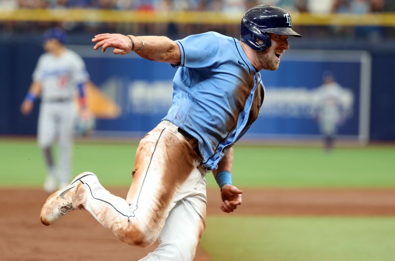 May 28, 2023; St. Petersburg, Florida, USA; Tampa Bay Rays right fielder Luke Raley (55) runs home to score a run against the Los Angeles Dodgers during the third inning at Tropicana Field. Mandatory Credit: Kim Klement-USA TODAY Sports