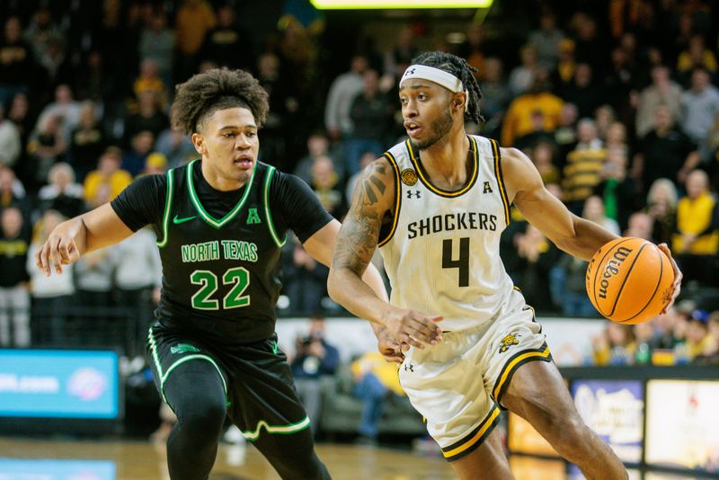 Jan 4, 2024; Wichita, Kansas, USA; Wichita State Shockers guard Colby Rogers (4) drives around North Texas Mean Green guard CJ Noland (22) during the first half at Charles Koch Arena. Mandatory Credit: William Purnell-USA TODAY Sports