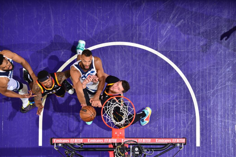 PHOENIX, AZ - APRIL 26:  Rudy Gobert #27 of the Minnesota Timberwolves drives to the basket during the game against the Phoenix Suns during Round 1 Game 3 of the 2024 NBA Playoffs on April 26, 2024 at Footprint Center in Phoenix, Arizona. NOTE TO USER: User expressly acknowledges and agrees that, by downloading and or using this photograph, user is consenting to the terms and conditions of the Getty Images License Agreement. Mandatory Copyright Notice: Copyright 2024 NBAE (Photo by Barry Gossage/NBAE via Getty Images)