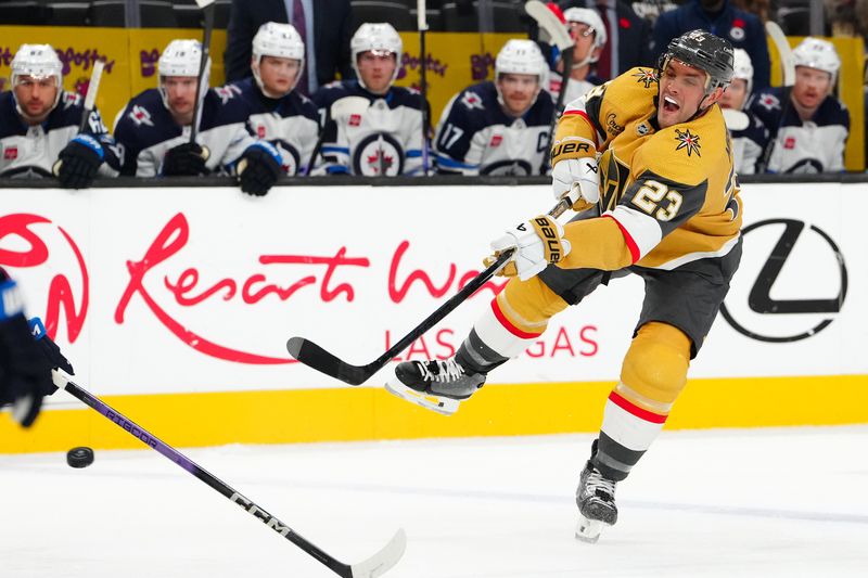 Nov 2, 2023; Las Vegas, Nevada, USA; Vegas Golden Knights defenseman Alec Martinez (23) shoots against the Winnipeg Jets during the first period at T-Mobile Arena. Mandatory Credit: Stephen R. Sylvanie-USA TODAY Sports