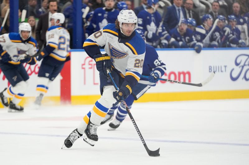 Oct 24, 2024; Toronto, Ontario, CAN; St. Louis Blues forward Brandon Saad (20) carries the puck against the Toronto Maple Leafs during the second period at Scotiabank Arena. Mandatory Credit: John E. Sokolowski-Imagn Images