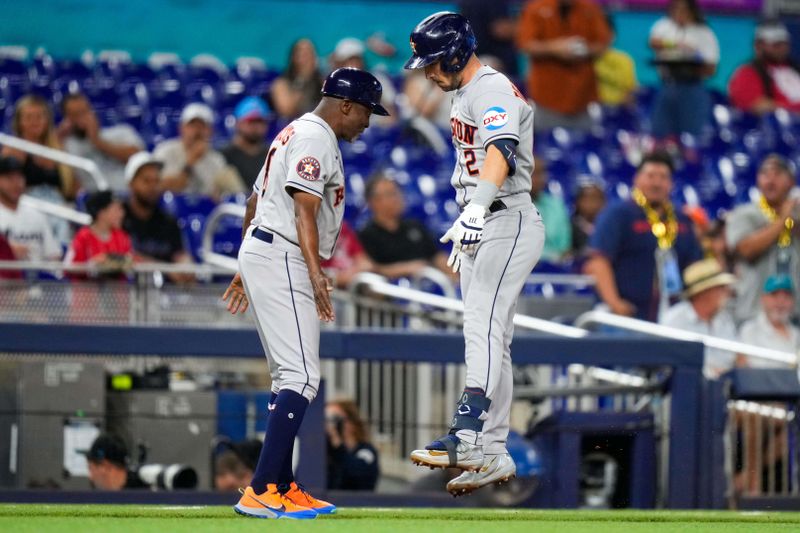 Aug 16, 2023; Miami, Florida, USA; Houston Astros third baseman Alex Bregman (2) celebrates with Houston Astros third base coach Gary Pettis (8) whilst rounds the base after hitting a home run against the Miami Marlins during the first inning at loanDepot Park. Mandatory Credit: Rich Storry-USA TODAY Sports