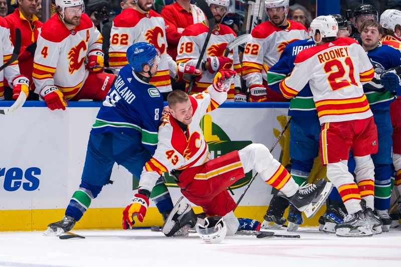 Apr 16, 2024; Vancouver, British Columbia, CAN; Calgary Flames forward Adam Klapka (43) wrestles with Vancouver Canucks forward Conor Garland (8) in the second period at Rogers Arena. Mandatory Credit: Bob Frid-USA TODAY Sports