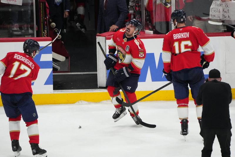 Jun 9, 2025; Sunrise, Florida, USA; Florida Panthers forward Brad Marchand (63) reacts as forward Evan Rodrigues (17) shoots a rat after the game against the Edmonton Oilers in game three of the 2025 Stanley Cup Final at Amerant Bank Arena. Mandatory Credit: Jim Rassol-Imagn Images
