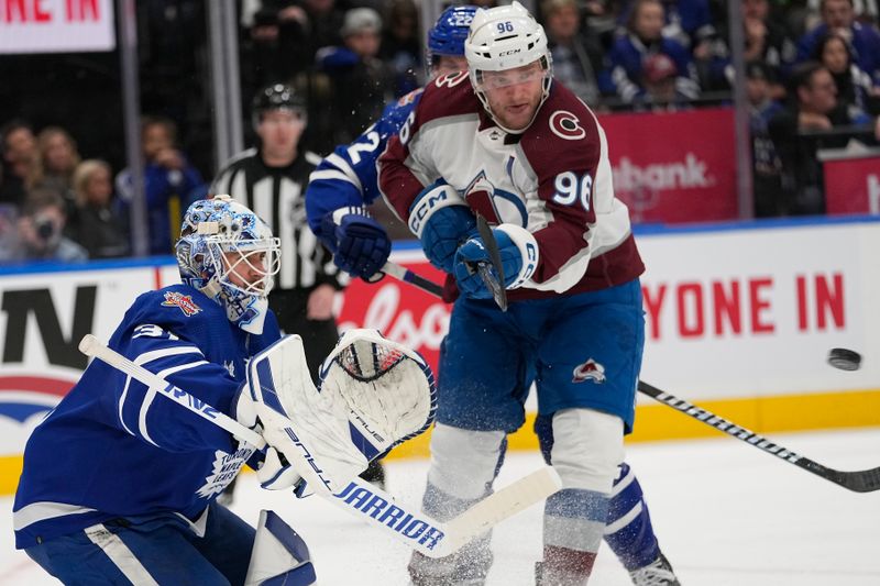 Jan 13, 2024; Toronto, Ontario, CAN; Colorado Avalanche forward Mikko Rantanen (96) tries tip a shot on Toronto Maple Leafs goaltender Martin Jones (31) during the second period at Scotiabank Arena. Mandatory Credit: John E. Sokolowski-USA TODAY Sports