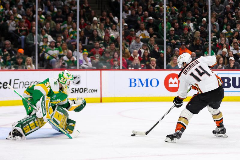 Jan 27, 2024; Saint Paul, Minnesota, USA; Anaheim Ducks center Adam Henrique (14) skates with the puck as Minnesota Wild goaltender Filip Gustavsson (32) defends his net during the second period at Xcel Energy Center. Mandatory Credit: Matt Krohn-USA TODAY Sports