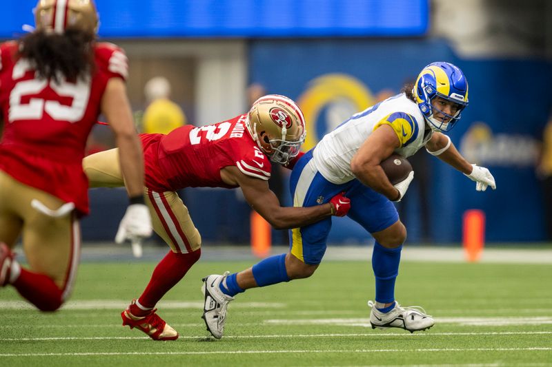 Los Angeles Rams wide receiver Puka Nacua (17) runs with the ball as San Francisco 49ers cornerback Deommodore Lenoir (2) tackles during an NFL football game, Sunday, Sept. 17, 2023, in Inglewood, Calif. (AP Photo/Kyusung Gong)