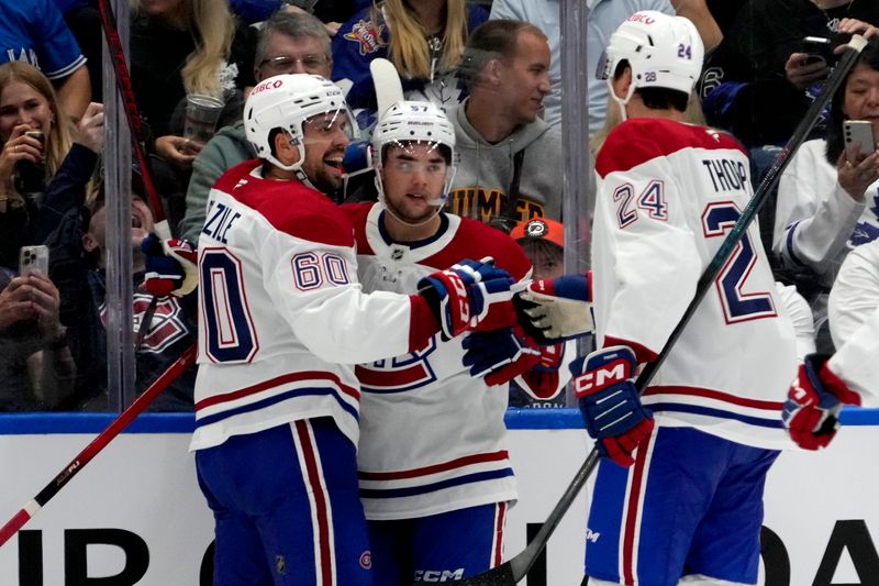 Sep 27, 2025; Toronto, Ontario, CAN; Montreal Canadiens forward Alex Belzile (60) and forward Tyler Thorpe (24)  congratulate forward Sean Farrell (57) on his goal against the Toronto Maple Leafs  during the third period at Scotiabank Arena. Mandatory Credit: John E. Sokolowski-Imagn Images