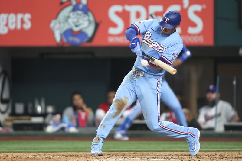 Apr 6, 2025; Arlington, Texas, USA; Texas Rangers catcher Jonah Heim (28) singles in the winning run in the bottom of the ninth inning against the Tampa Bay Rays at Globe Life Field. Mandatory Credit: Tim Heitman-Imagn Images