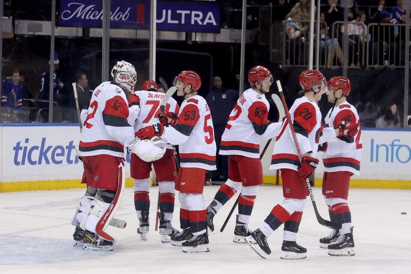 Feb 5, 2026; New York, New York, USA; Carolina Hurricanes goaltender Brandon Bussi (32) celebrates with teammates after defeating the New York Rangers at Madison Square Garden. Mandatory Credit: Brad Penner-Imagn Images
