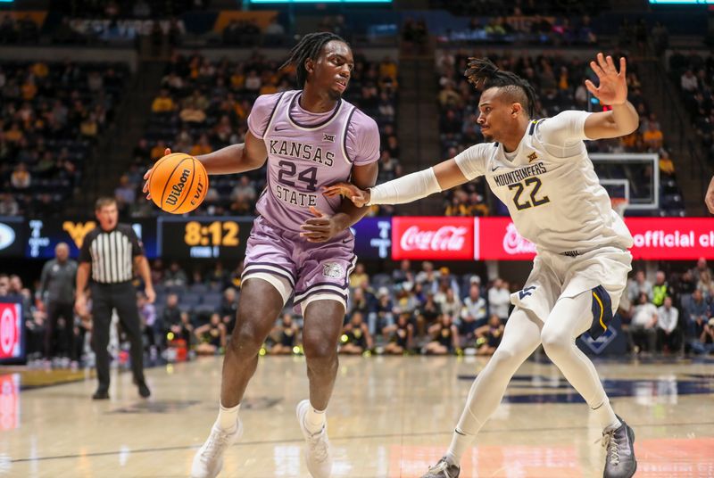 Jan 9, 2024; Morgantown, West Virginia, USA; Kansas State Wildcats forward Arthur Kaluma (24) dribbles against West Virginia Mountaineers forward Josiah Harris (22) during the first half at WVU Coliseum. Mandatory Credit: Ben Queen-USA TODAY Sports