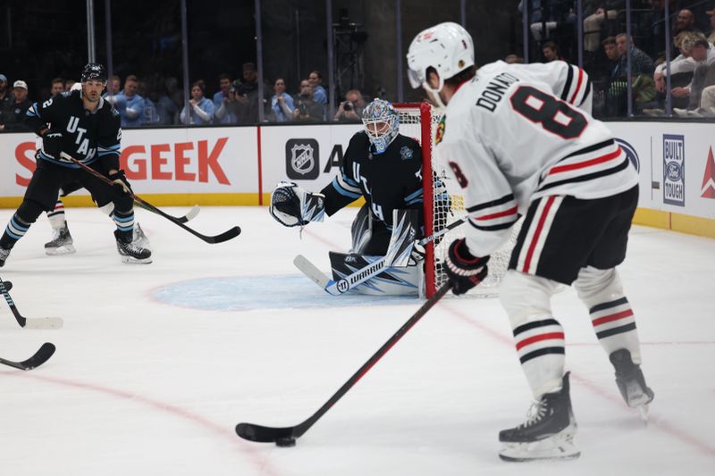 Feb 25, 2025; Salt Lake City, Utah, USA; Chicago Blackhawks center Ryan Donato (8) looks for a play against the Utah Hockey Club during the second period at Delta Center. Mandatory Credit: Rob Gray-Imagn Images