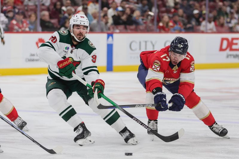 Jan 19, 2024; Sunrise, Florida, USA; Minnesota Wild left wing Marcus Johansson (90) moves the puck past Florida Panthers center Evan Rodrigues (17) during the first period at Amerant Bank Arena. Mandatory Credit: Sam Navarro-USA TODAY Sports